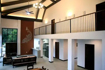 a living room with a staircase in a house at Villa Ariana Family Getaway in Bukal