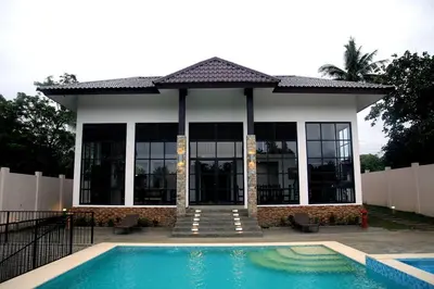 a house with a swimming pool in front of it at Villa Ariana Family Getaway in Bukal