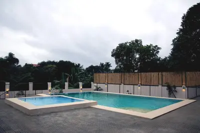 a swimming pool in the middle of a patio at Villa Ariana Family Getaway in Bukal