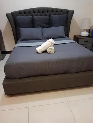 a white towel laying on a bed in a bedroom at Newport 101 - East Wing in Manila