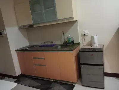 a small kitchen with a sink and a refrigerator at Newport 101 - East Wing in Manila
