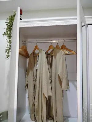 a closet filled with lots of clothes at StayWise Space Manila in Manila