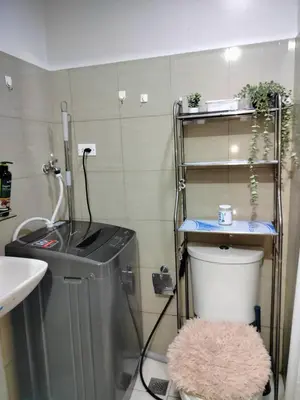 a small bathroom with a sink and a toilet at StayWise Space Manila in Manila