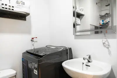 a bathroom with a sink and a mirror at Comfortable 2-Bedroom Home in Paranaque in Manila