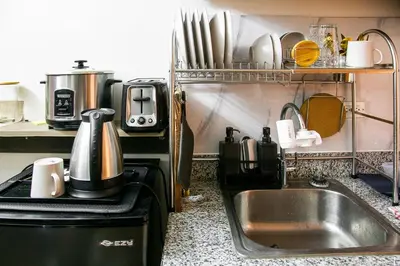 a kitchen with a sink and a counter top at Comfortable 2-Bedroom Home in Paranaque in Manila