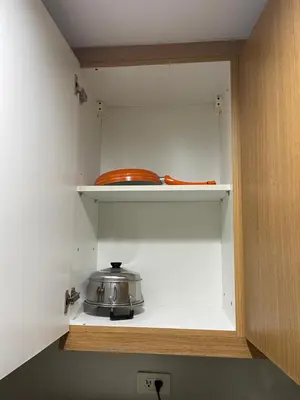 a kitchen with a tea pot on a shelf at Shell Residences in Manila