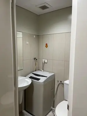 a small bathroom with a sink and a toilet at Shell Residences in Manila