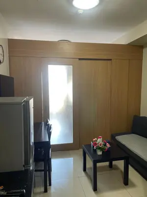 a living room with a couch and a tv at Shell Residences in Manila