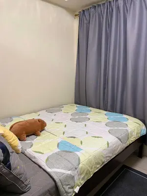 a bed with a stuffed animal on it in a bedroom at Shore Residences C1 in Manila