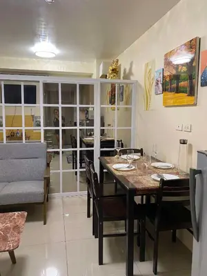 a dining room with a table and chairs at Shore Residences C1 in Manila