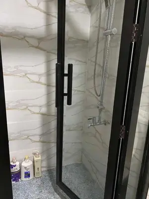 a shower with a glass door in a bathroom at Shore Residences C1 in Manila