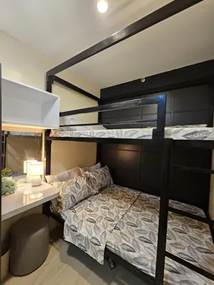 a bedroom with two bunk beds and a desk at NEAR NAIA TERMINAL 1, 2, 3 Cozy Apartment at Field Residence in Manila