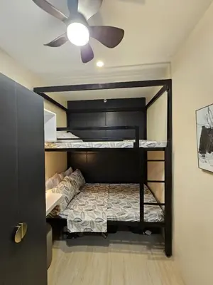 a bedroom with a bunk bed with a ceiling fan at NEAR NAIA TERMINAL 1, 2, 3 Cozy Apartment at Field Residence in Manila
