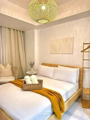 a bedroom with a bed with a blanket on it at Azure Urban Resort Staycation By J&R in Manila