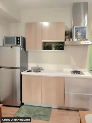 a kitchen with a sink and a refrigerator at Azure Urban Resort Staycation By J&R in Manila