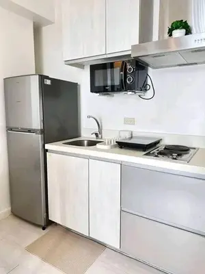 a kitchen with a stainless steel refrigerator and a sink at Azure Urban Resort Staycation By J&R in Manila