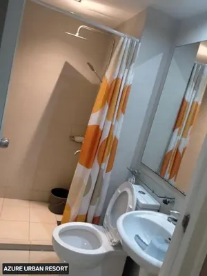 a bathroom with a toilet and a sink at Azure Urban Resort Staycation By J&R in Manila