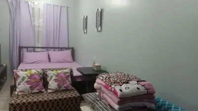 a bedroom with two beds and a small table with a table at Josephine Macatula in Santa Rosa