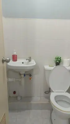 a bathroom with a toilet and a sink at Josephine Macatula in Santa Rosa