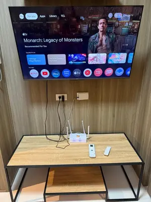 a table in a room with a tv on a wall at 2 bedroom Haven in Manila