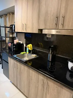 a kitchen with a sink and a microwave at 2 bedroom Haven in Manila