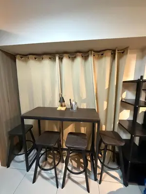 a dining room table with four chairs around it at 2 bedroom Haven in Manila