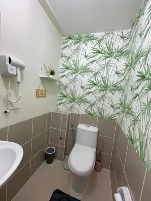 a bathroom with a toilet and a sink at Satori Residences in Manila