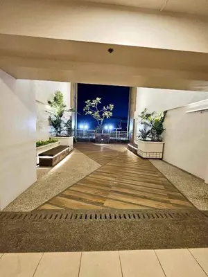 an empty hallway with a view of the ocean at night at Satori Residences in Manila