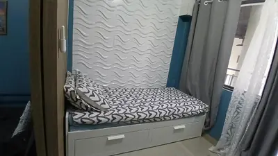 a bench in a room with a bed in a room at Shore 2 Residence Tower 2 in Manila