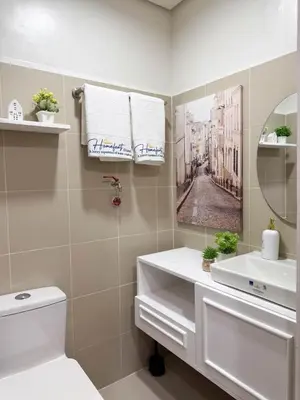 a bathroom with a sink and a mirror at Homefort Twin Bed Suite - Red Residences Makati 1146 in Manila