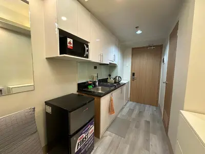 a small kitchen with a sink and a counter at Modern and Cozy Suite at Shore Residences in Manila