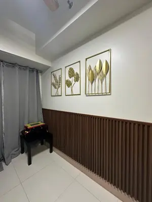a room with three pictures on the wall and a piano at Modern and Cozy Suite at Shore Residences in Manila