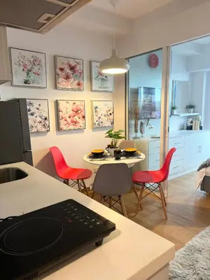 a kitchen and living room with a table and chairs at Staycation in Mandaluyong near Makati and BGC in Manila