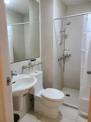 a white bathroom with a toilet and a sink at Staycation in Mandaluyong near Makati and BGC in Manila