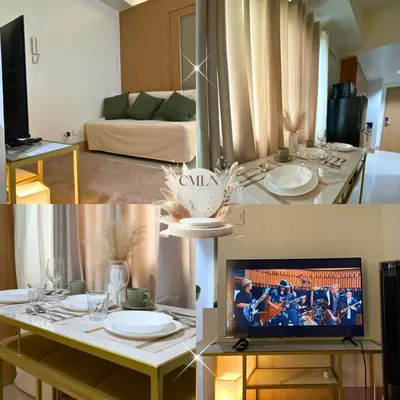 a living room with a table with a tv in it at cmln staycation metro manila in Manila