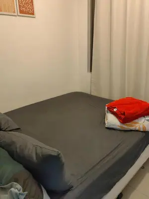 a bed with a red towel on it in a room at lhey's staycation in Manila