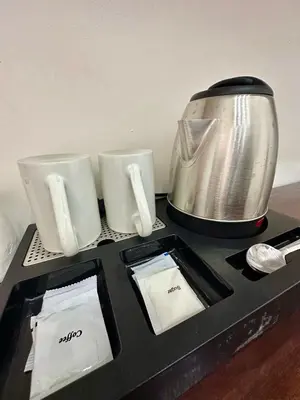 a table with a blender and two cups on it at Studio Two Condominium, Alabang - GOLD FIBER WI-FI -NETFLIX READY in Manila