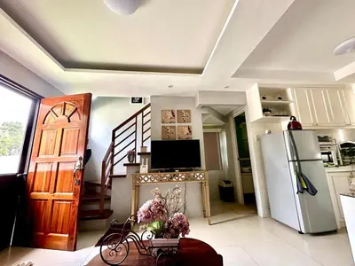 a kitchen with a refrigerator and a table with a bike at Havila, Amarilyo Home, Brgy San Juan, Taytay Rizal in Taytay