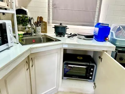 a kitchen with a sink and a microwave at Havila, Amarilyo Home, Brgy San Juan, Taytay Rizal in Taytay