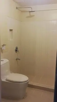 a bathroom with a toilet and a shower at Life in refinement at Ivory Wood in Manila