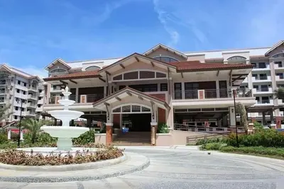 a large building with a fountain in front of it at Life in refinement at Ivory Wood in Manila
