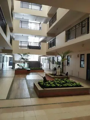 a large building with a courtyard with plants in it at Life in refinement at Ivory Wood in Manila