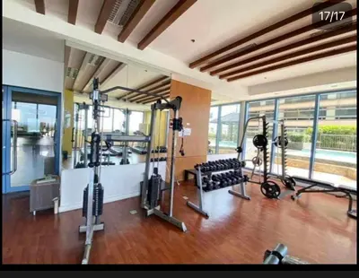 a gym with several treadmills and tread machines at FamilyRoom 1 bedroom in Manila