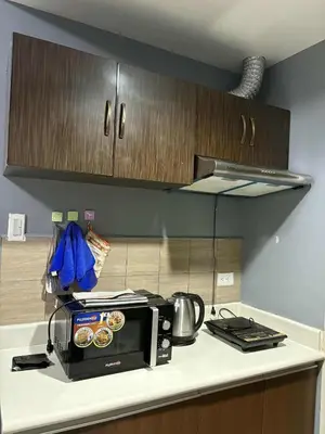 a kitchen with a microwave on a counter at FamilyRoom 1 bedroom in Manila