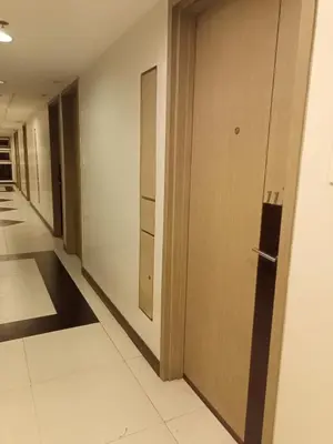a hallway with a door in a building at Condo Near MOA and NAIA at SoleMare Parksuites in Manila