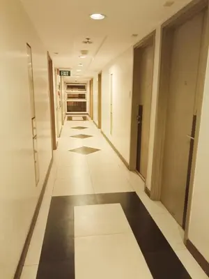 a corridor of an office building with black and white floors at Condo Near MOA and NAIA at SoleMare Parksuites in Manila