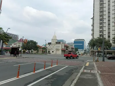 a city street with a red car driving down the street at Condo Near MOA and NAIA at SoleMare Parksuites in Manila