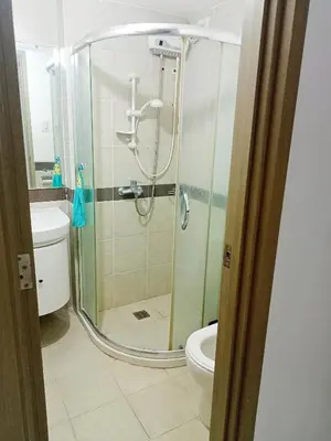 a bathroom with a shower and a toilet at Condo Near MOA and NAIA at SoleMare Parksuites in Manila
