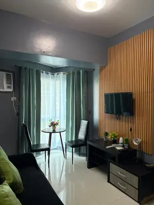 a living room with a couch and a table at Family budget room, infront US of Embassy in Manila