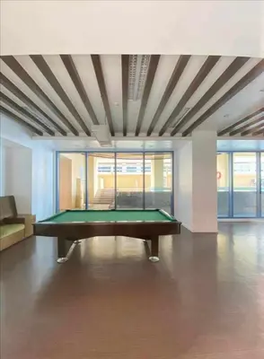 a pool table in the middle of a room at Family budget room, infront US of Embassy in Manila